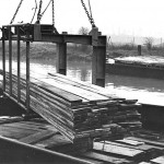 Off-loading timber from the River Lea into the Lebus storage and drying sheds